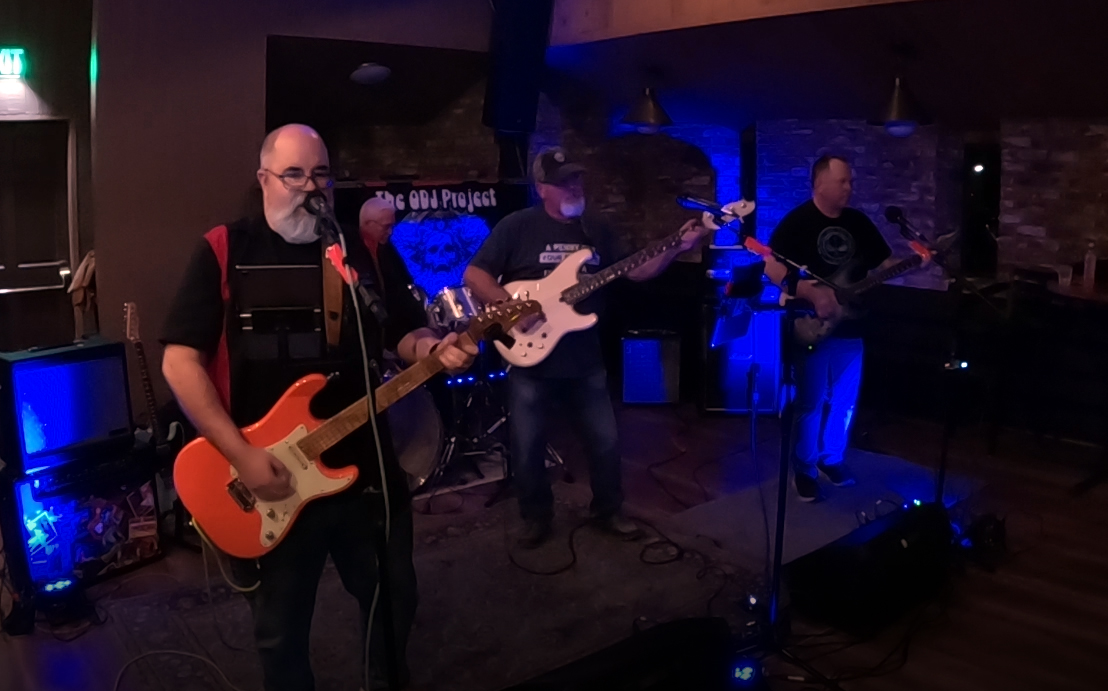 ODJ Project guitarist performing live outdoors